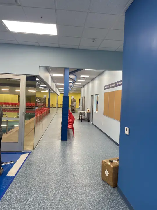 Blue gray flake epoxy floor in a commercial gym hallway in Fort Lauderdale, FL