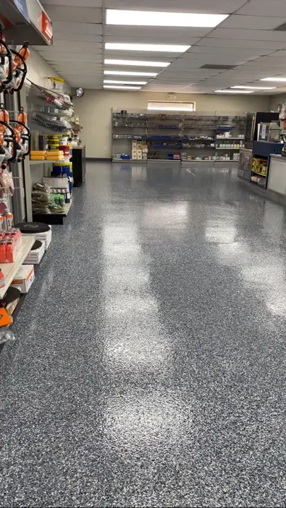 Flake epoxy floor down the aisle of a retail store in Fort Lauderdale, FL