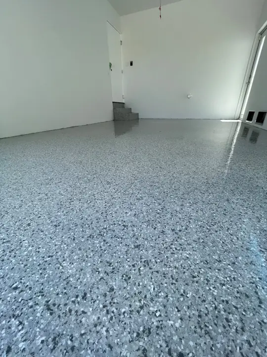 Close up of a gray, black and white flake epoxy floor in Fort Lauderdale, FL