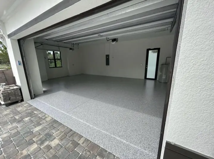 Flake epoxy garage floor seen from the paver driveway in Fort Lauderdale, FL