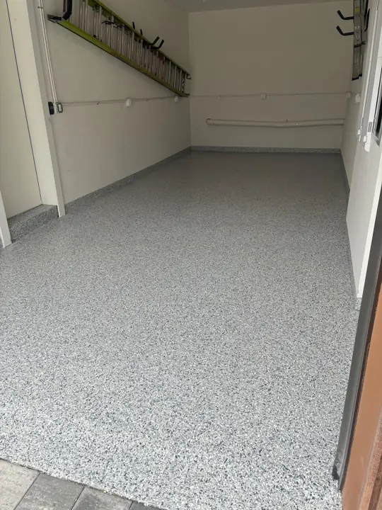 Narrow garage with a gray flake epoxy floor in Fort Lauderdale, FL