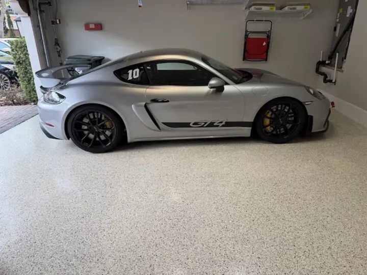 Silver sports car on a light flake epoxy garage floor in Fort Lauderdale, FL