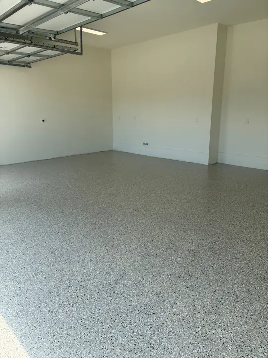 Flake epoxy garage floor with white walls in Fort Lauderdale, FL