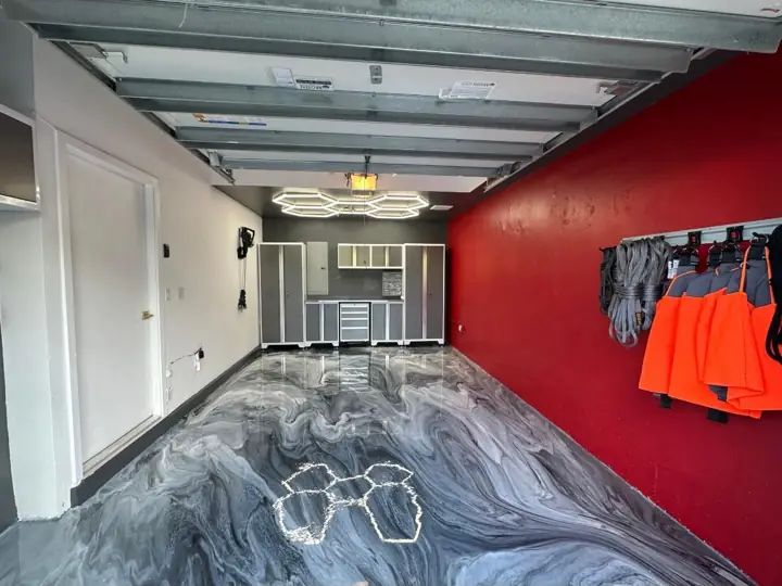 Gray metallic epoxy garage floor beside a red wall in Fort Lauderdale, FL